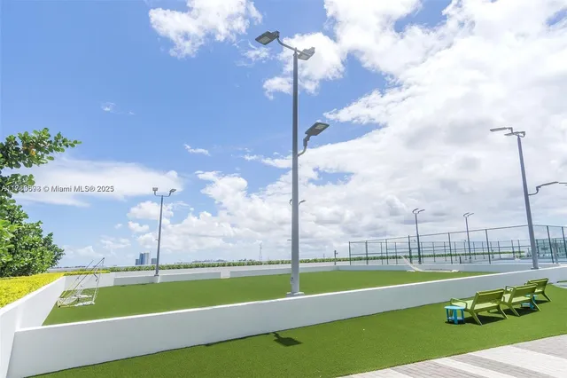 a swimming pool with outdoor seating and yard