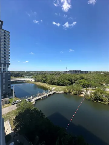 a view of kitchen with cabinets and window