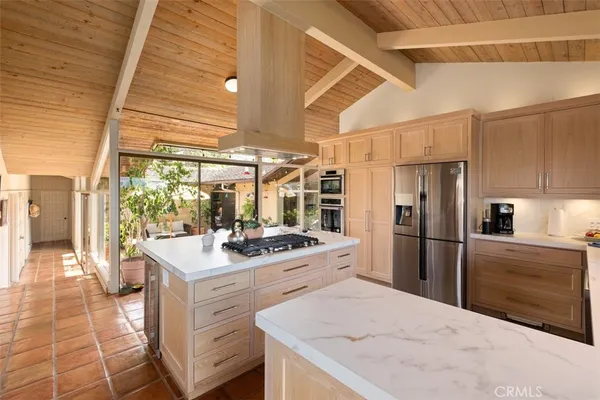 a outdoor space with the couches and dining table with the garden view