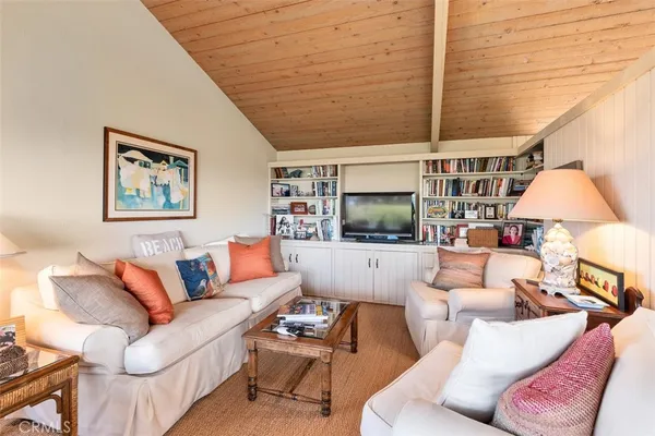 a view of a patio with couches table and chairs and potted plants