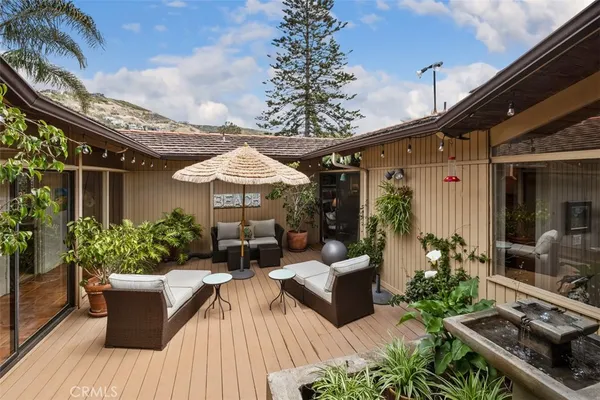 a outdoor dining space with furniture and wooden floor