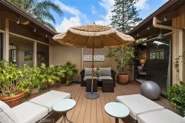 a building outdoor space with patio furniture and potted plants