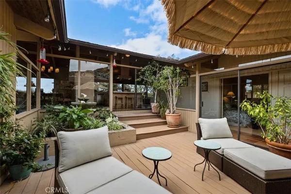 a bedroom with furniture and a large window