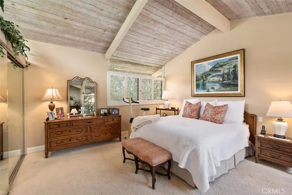 a bedroom with a bed a table and chair