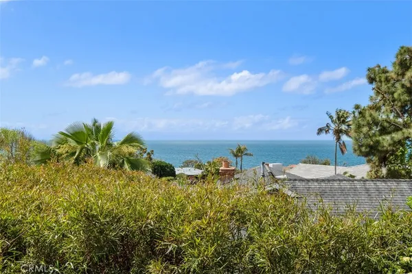 a view of a lake with a table and chairs