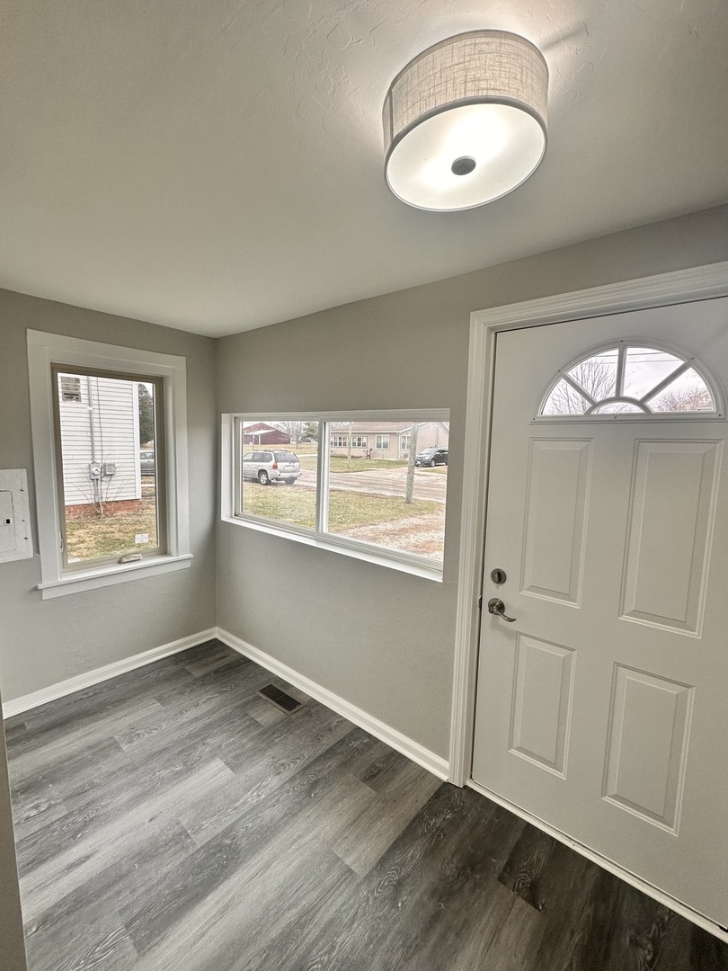 920 Hall Street Streator, IL 61364 - Photo 2 of 19 a view of an empty room with wooden floor and a window