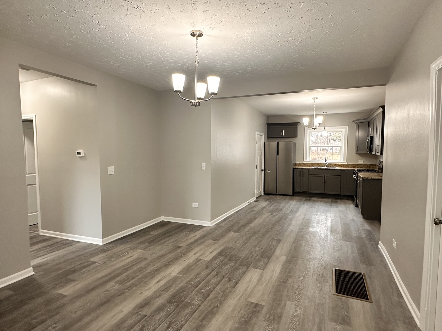 920 Hall Street Streator, IL 61364 - Photo 3 of 19 wooden floor in an empty room with a kitchen