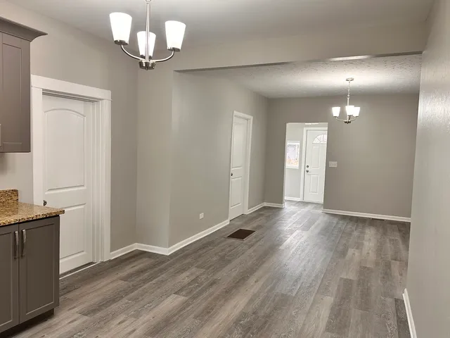 wooden floor in an empty room with a mirror