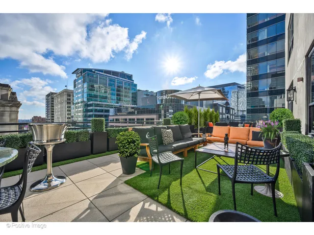 a view of a patio with couches table and chairs and potted plants