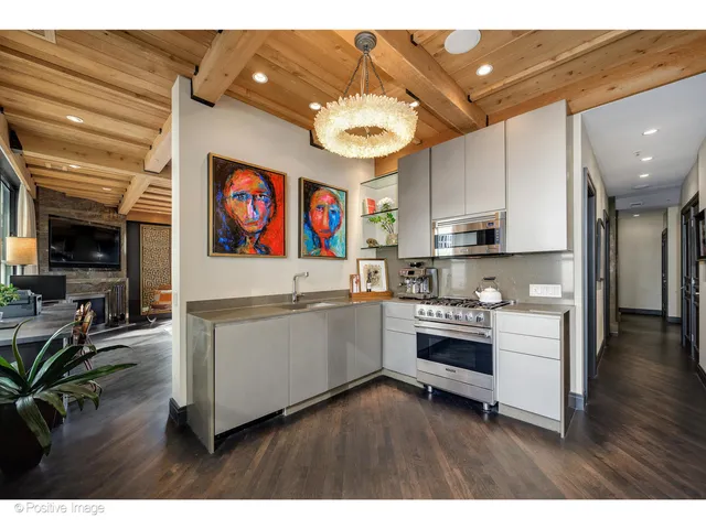 a open kitchen with stainless steel appliances granite countertop a lot of counter space and a window