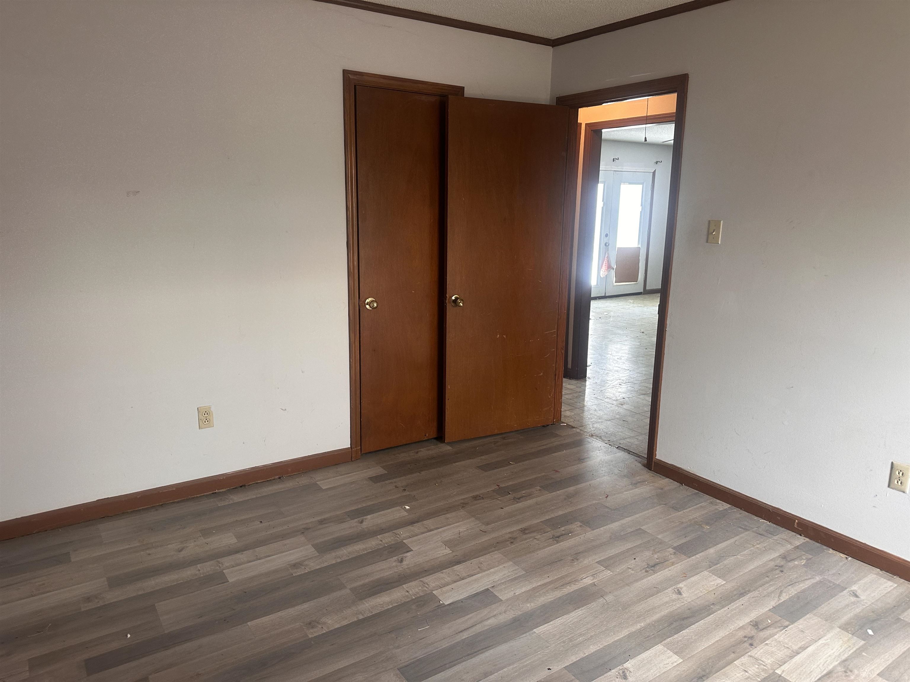 605 Jr Drive Covington, TN 38019 - Photo 16 of 21 Empty room with wood finished floors and ornamental molding