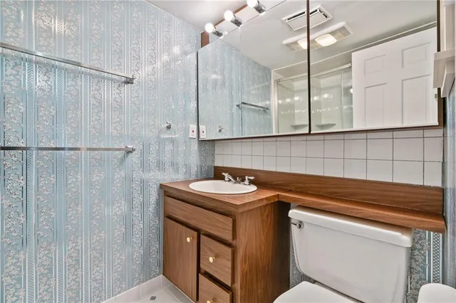 a bathroom with a glass shower door