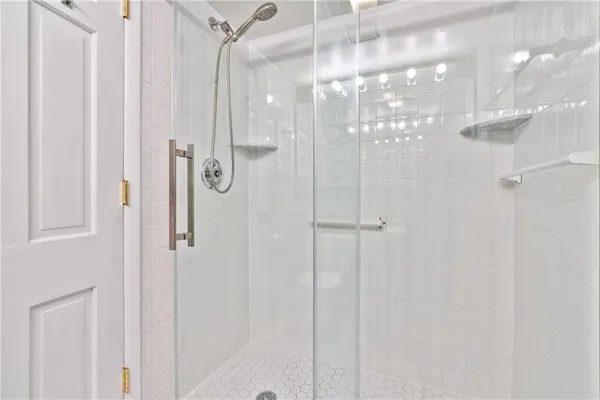 a bathroom with a granite countertop sink toilet a mirror and shower