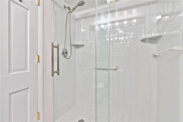 a bathroom with a granite countertop sink toilet a mirror and shower