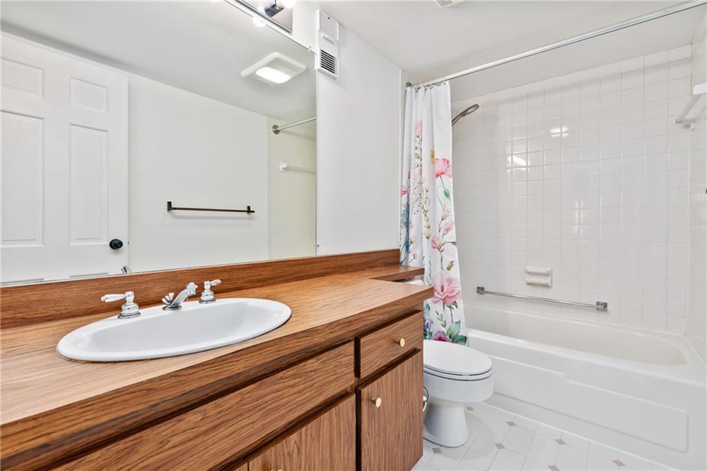 5600 Munhall Road, Unit 203 Pittsburgh, PA 15217 - Photo 20 of 31 a bathroom with a granite countertop sink toilet a mirror and shower