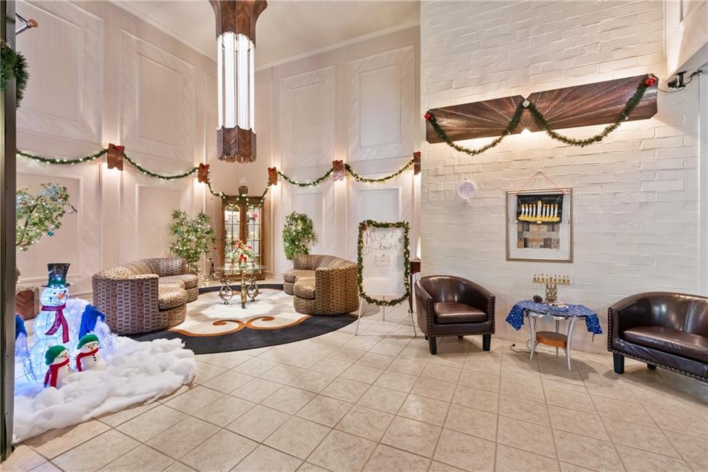 5600 Munhall Road, Unit 203 Pittsburgh, PA 15217 - Photo 5 of 31 a living room with furniture a chandelier and a fireplace