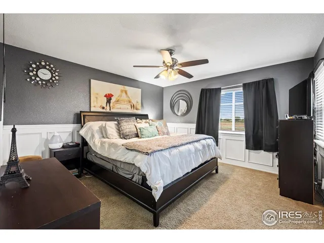 a view of a livingroom with furniture and a ceiling fan