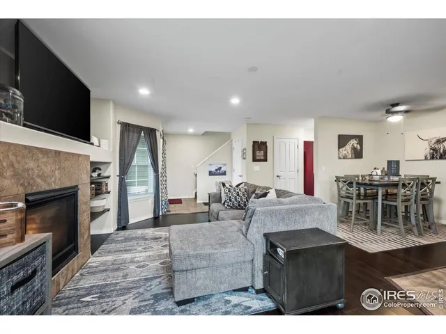 a living room with furniture a flat screen tv and a fireplace