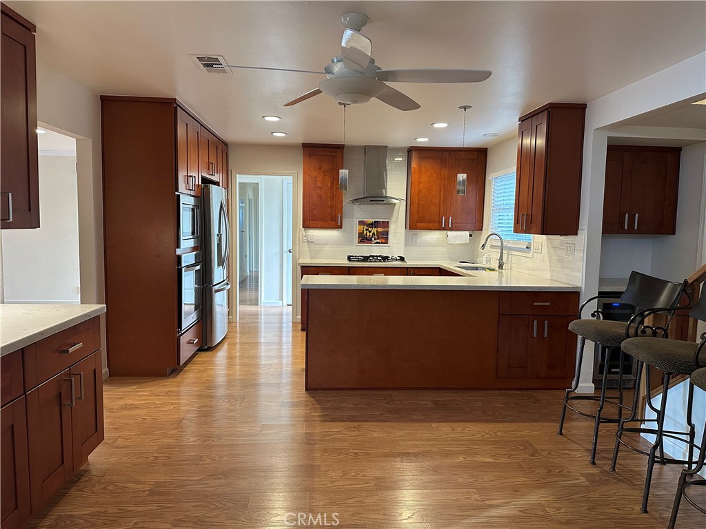 16768 Buckeye Circle Fountain Valley, CA 92708 - Photo 3 of 17 a kitchen with stainless steel appliances granite countertop a sink stove and refrigerator