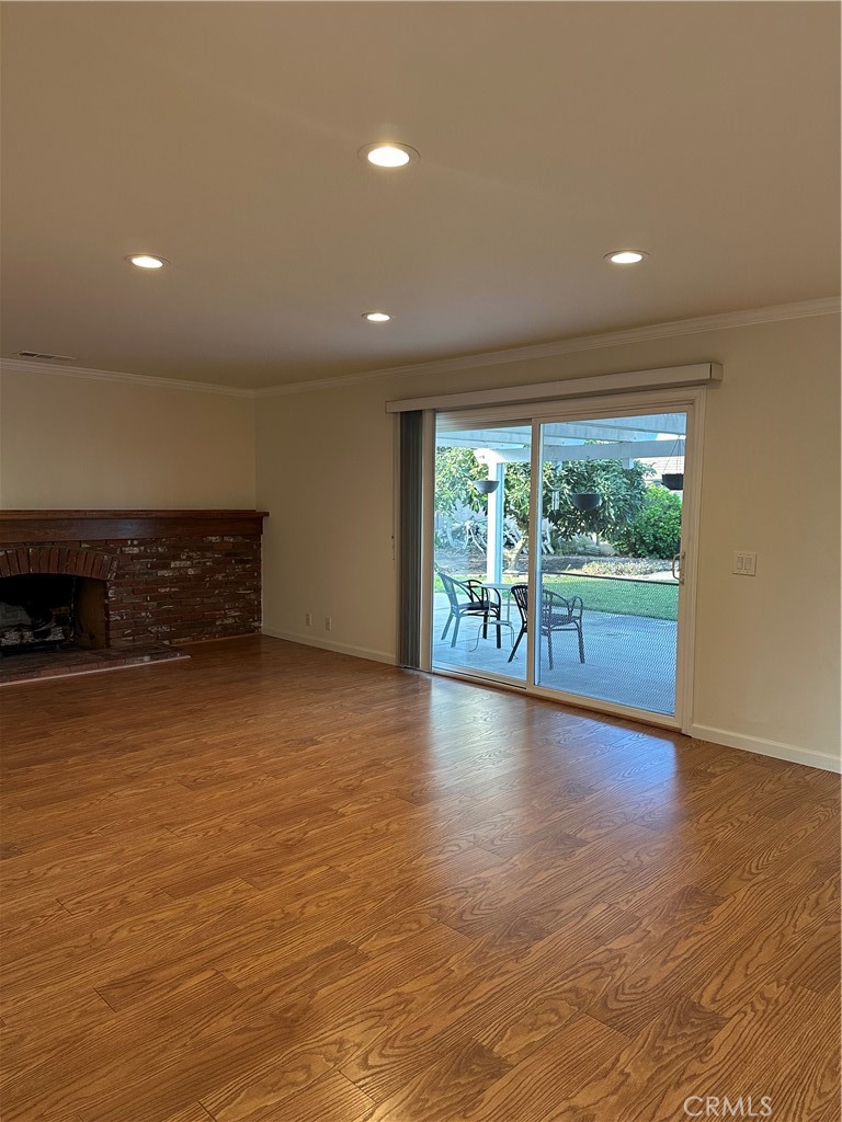 16768 Buckeye Circle Fountain Valley, CA 92708 - Photo 6 of 17 a view of empty room with wooden floor and fireplace