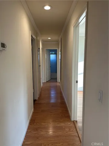 a view of a hallway with wooden floor