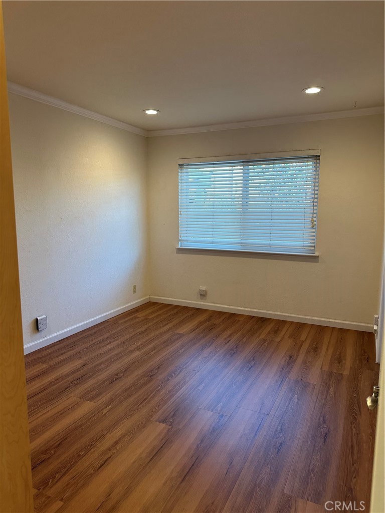 16768 Buckeye Circle Fountain Valley, CA 92708 - Photo 8 of 17 an empty room with wooden floor and windows