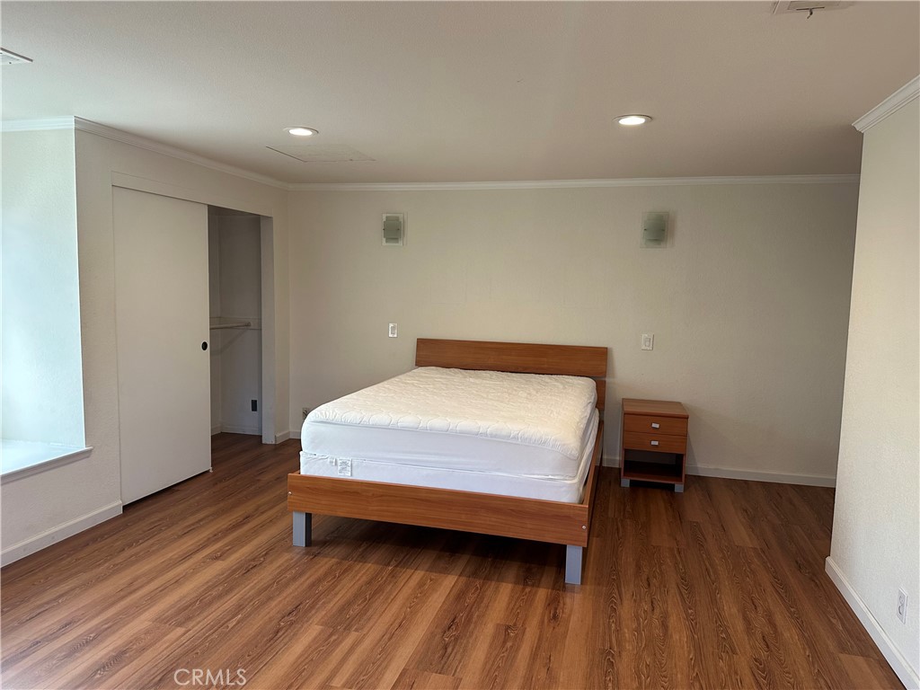 16768 Buckeye Circle Fountain Valley, CA 92708 - Photo 10 of 17 a bedroom with a bed and wooden floor