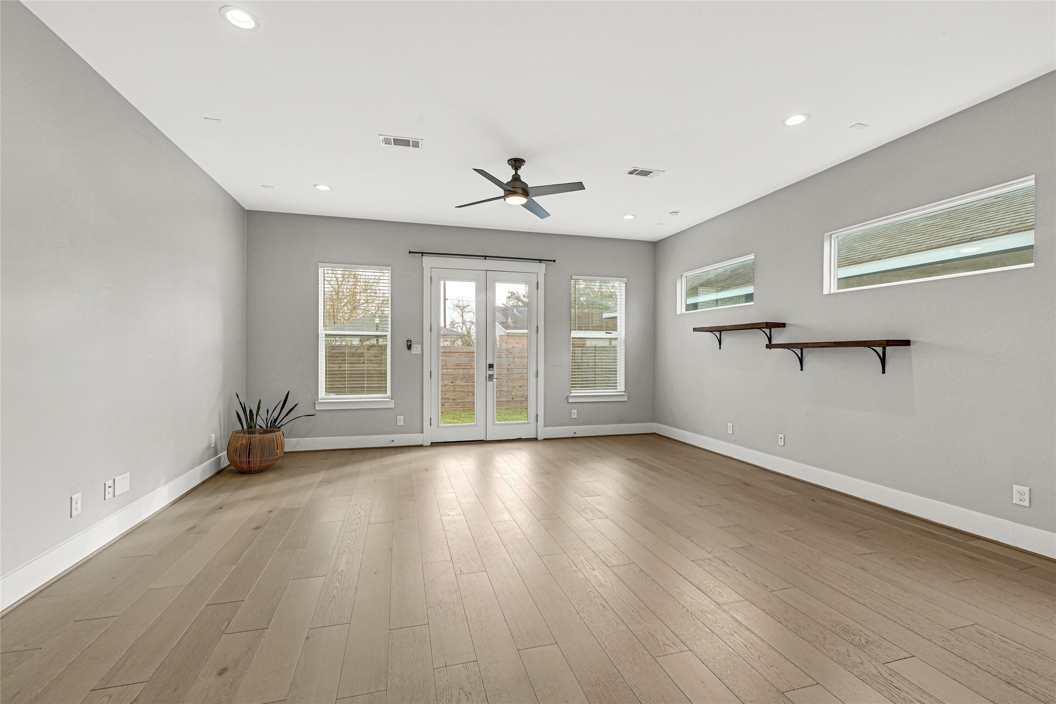 4506 Hardy Street, Unit A Houston, TX 77009 - Photo 11 of 35 a view of an empty room with a window and wooden floor