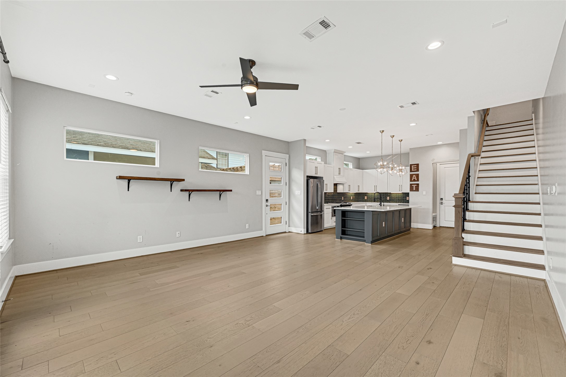 4506 Hardy Street, Unit A Houston, TX 77009 - Photo 13 of 35 a view of a kitchen with a sink and dishwasher a refrigerator with wooden floor