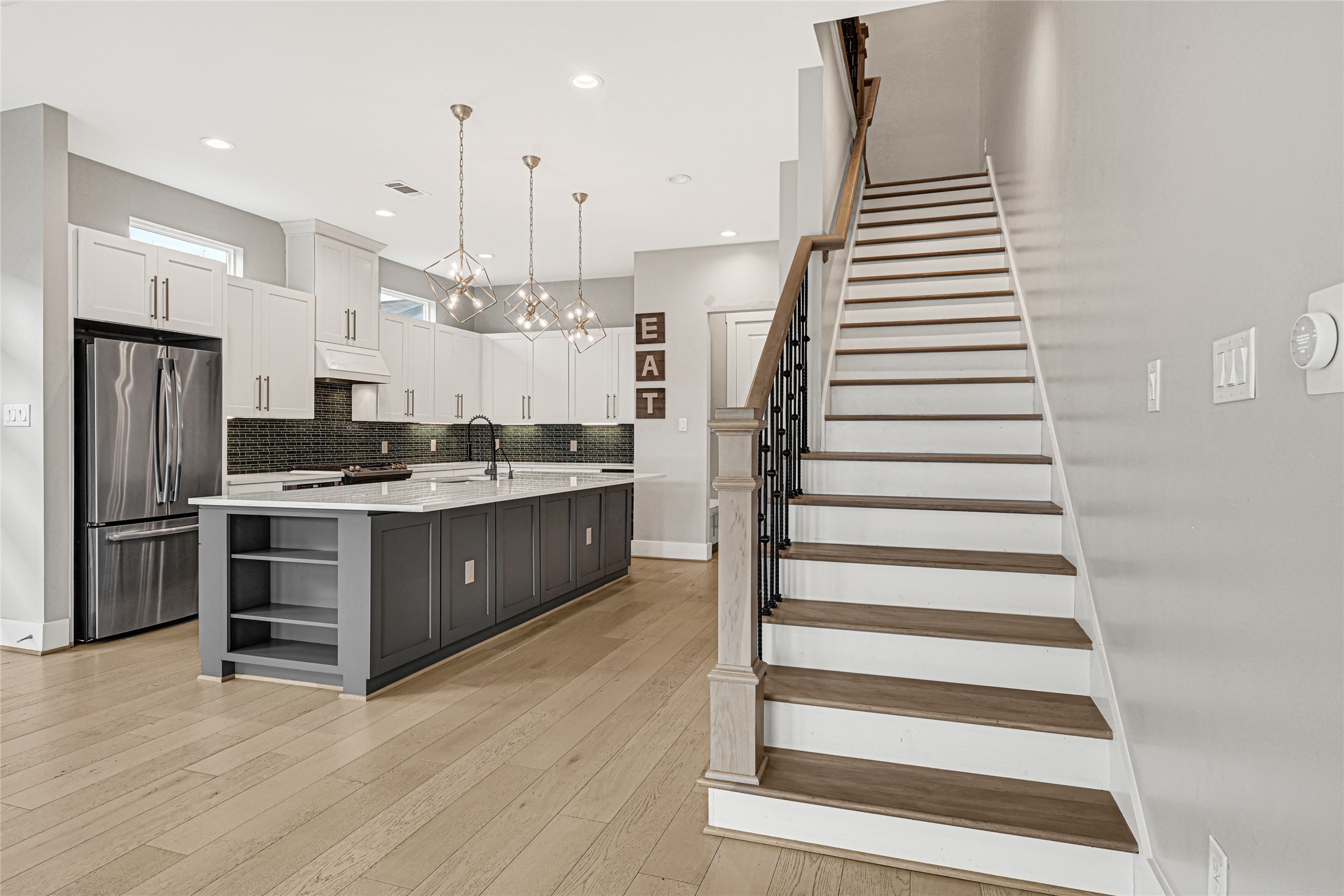 4506 Hardy Street, Unit A Houston, TX 77009 - Photo 14 of 35 a kitchen with stainless steel appliances kitchen island wooden cabinets and a stove top oven