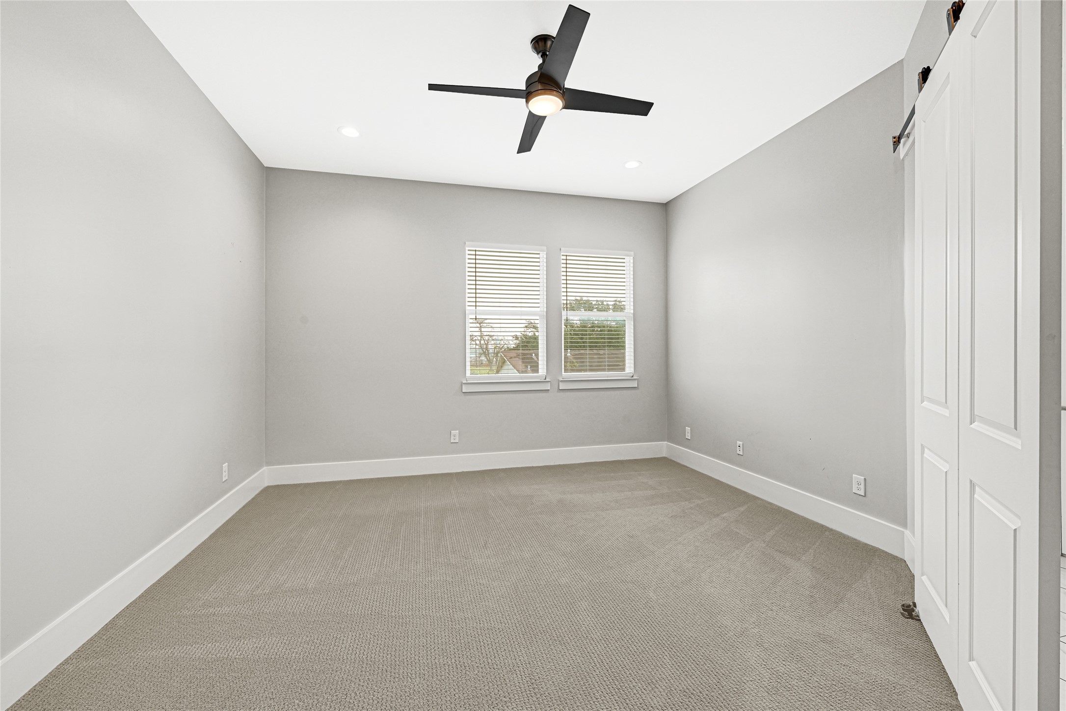 4506 Hardy Street, Unit A Houston, TX 77009 - Photo 20 of 35 an empty room with windows and ceiling fan