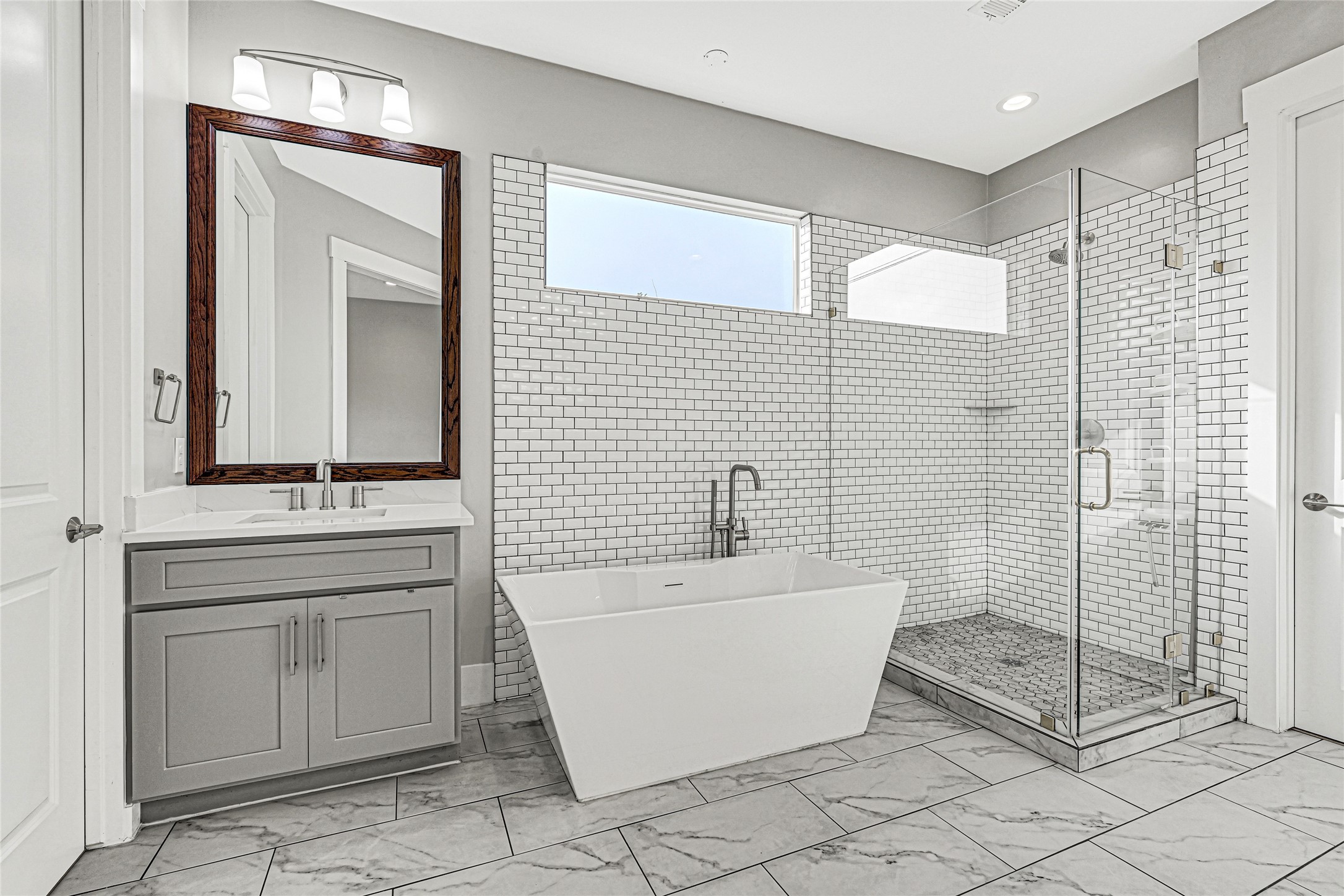 4506 Hardy Street, Unit A Houston, TX 77009 - Photo 21 of 35 a bathroom with a double vanity sink a mirror and a bathtub