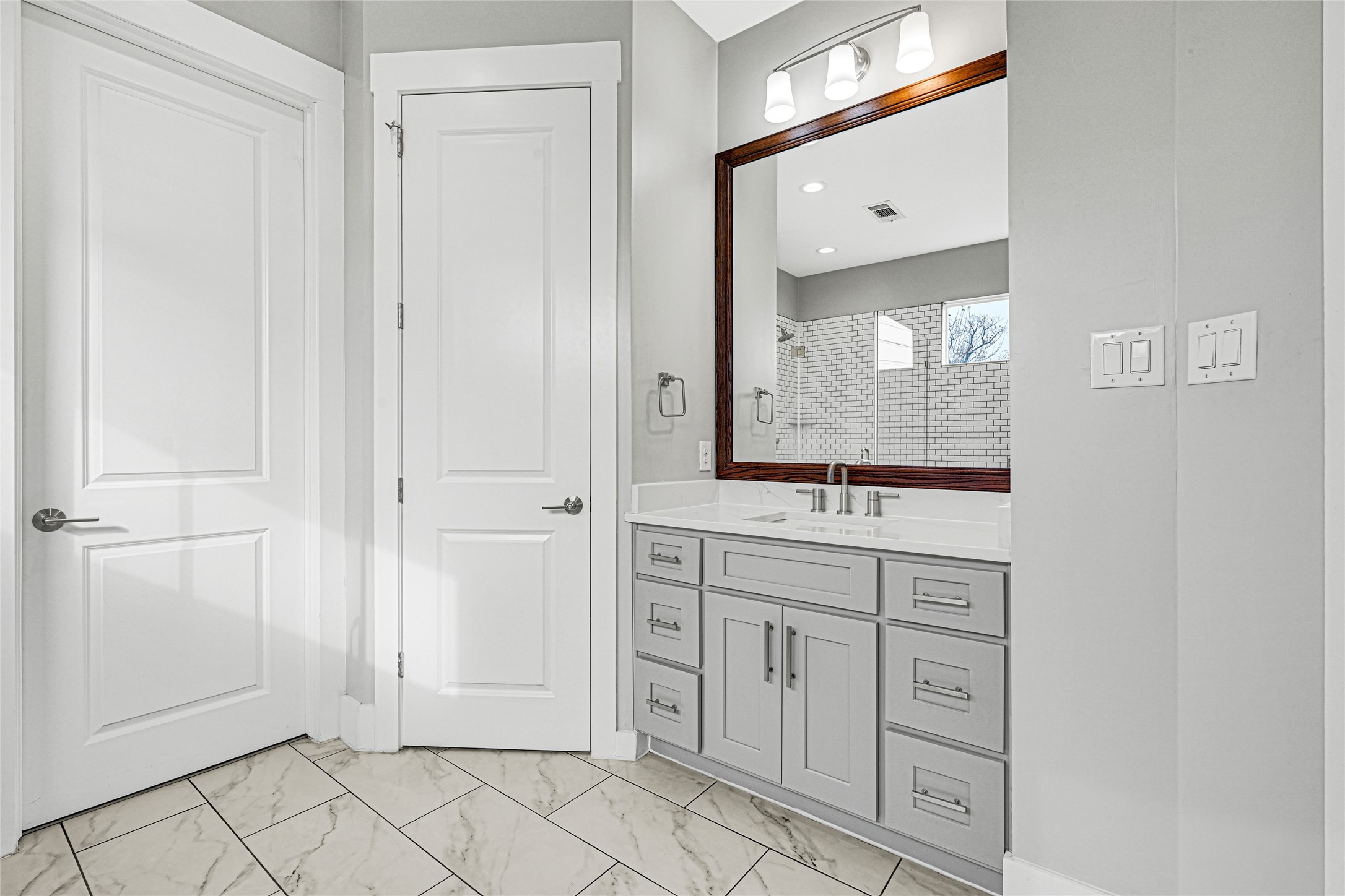 4506 Hardy Street, Unit A Houston, TX 77009 - Photo 22 of 35 a spacious bathroom with a mirror and a sink