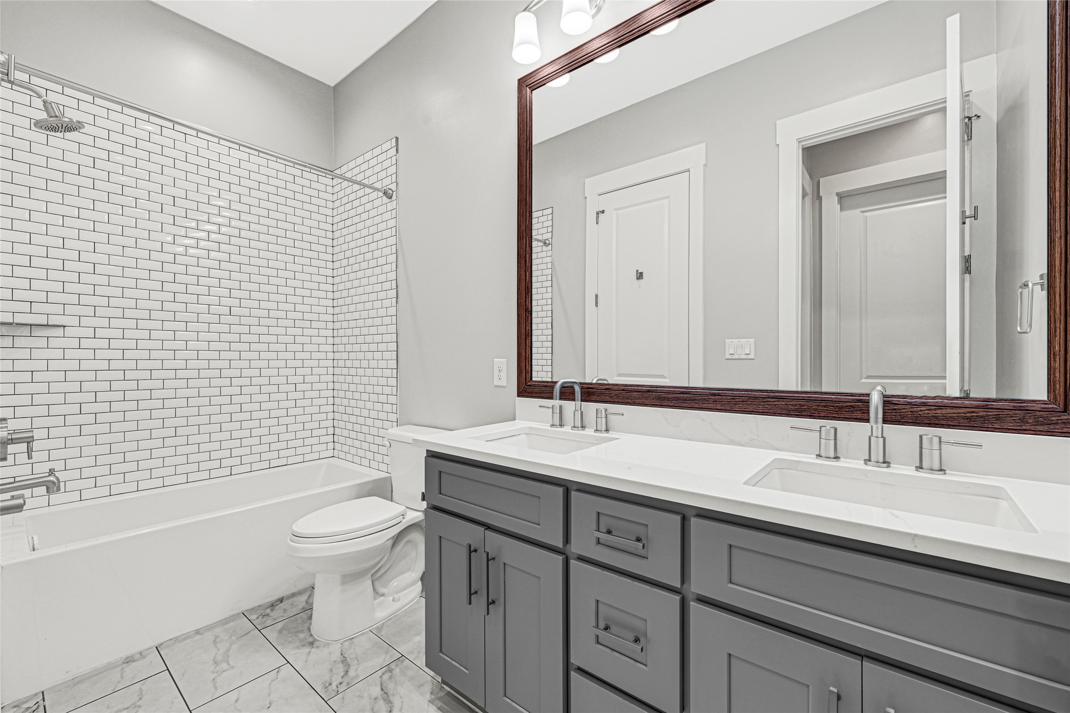 4506 Hardy Street, Unit A Houston, TX 77009 - Photo 27 of 35 a bathroom with a double vanity sink toilet and shower