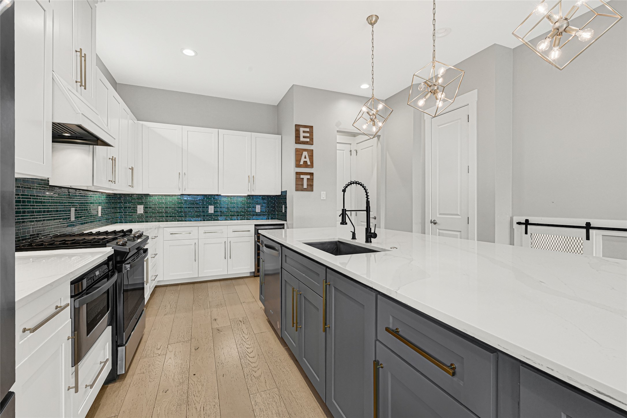 4506 Hardy Street, Unit A Houston, TX 77009 - Photo 7 of 35 a kitchen with stainless steel appliances a sink dishwasher a stove top oven a refrigerator with island and chairs