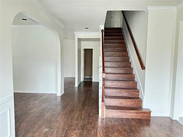 a view of entryway and hall with wooden floor