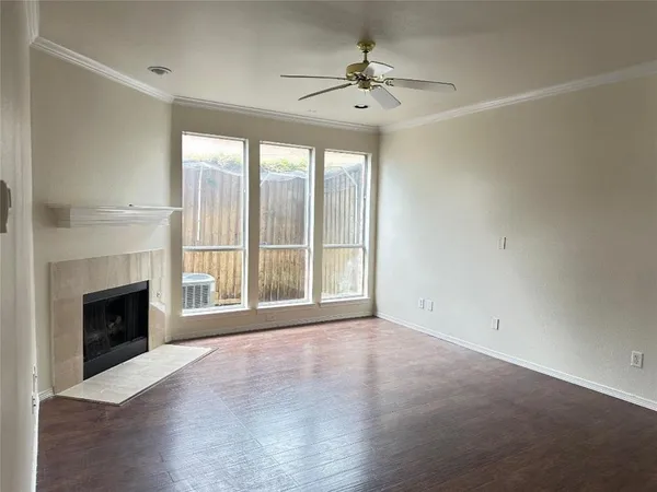 a view of an empty room with a fireplace and a window