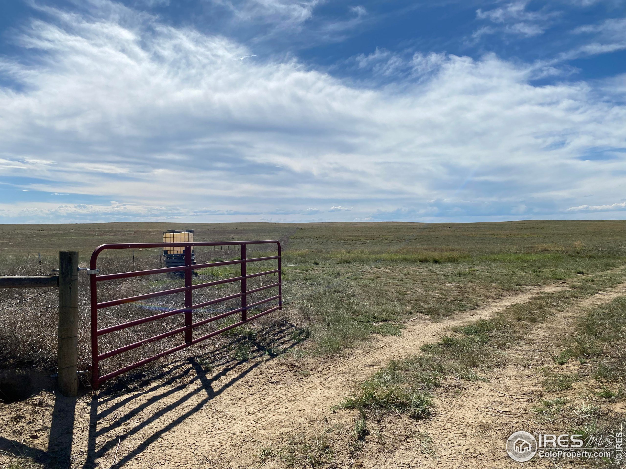93 Weld County Rd Orchard, Unit TRACT 2 Orchard, CO 80649 - Photo 2 of 8 a view of a lake with a yard