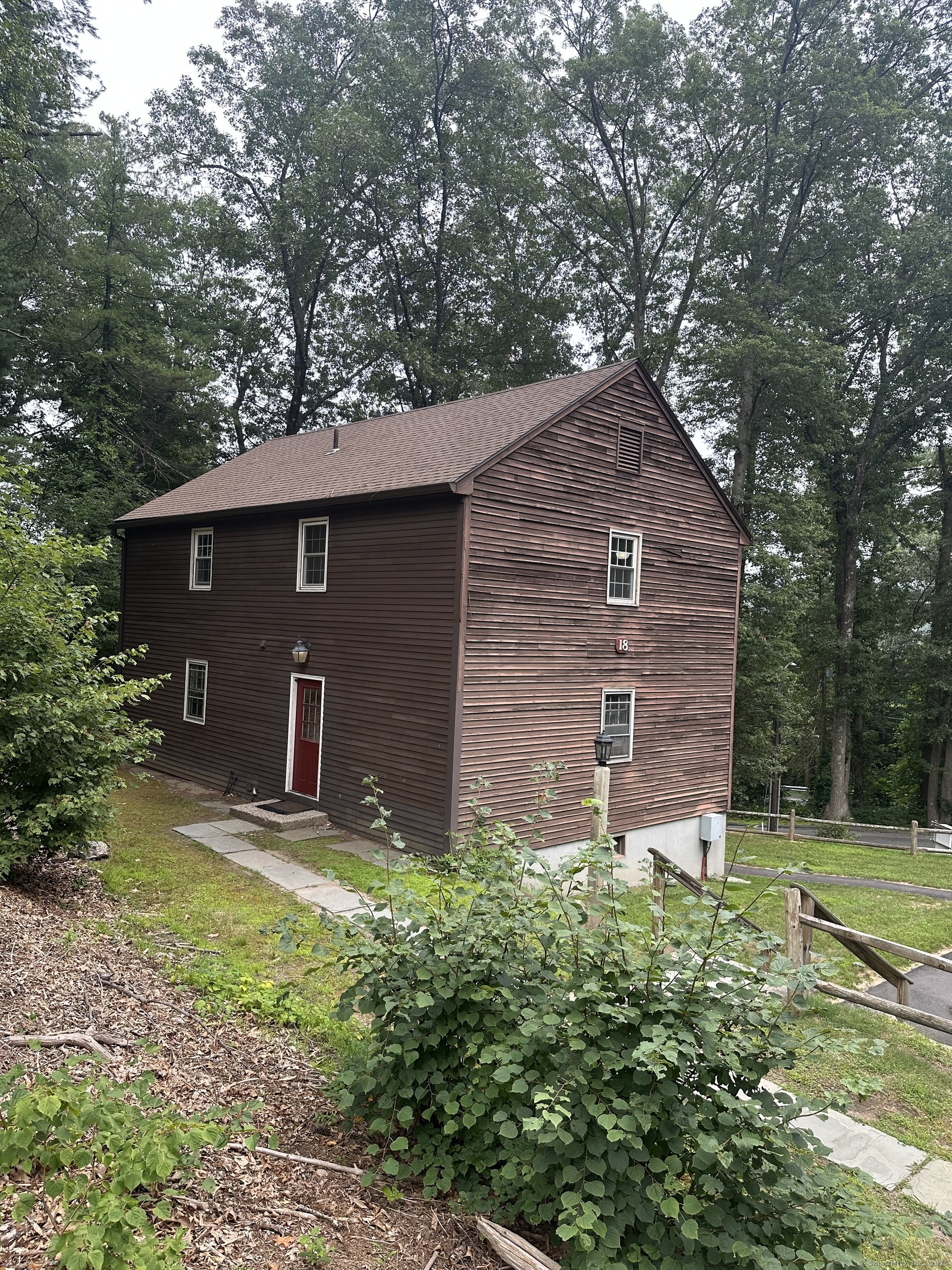 239 Old Farms Road, Unit 18B Avon, CT 06001 - Photo 1 of 1 a front view of a house with garden