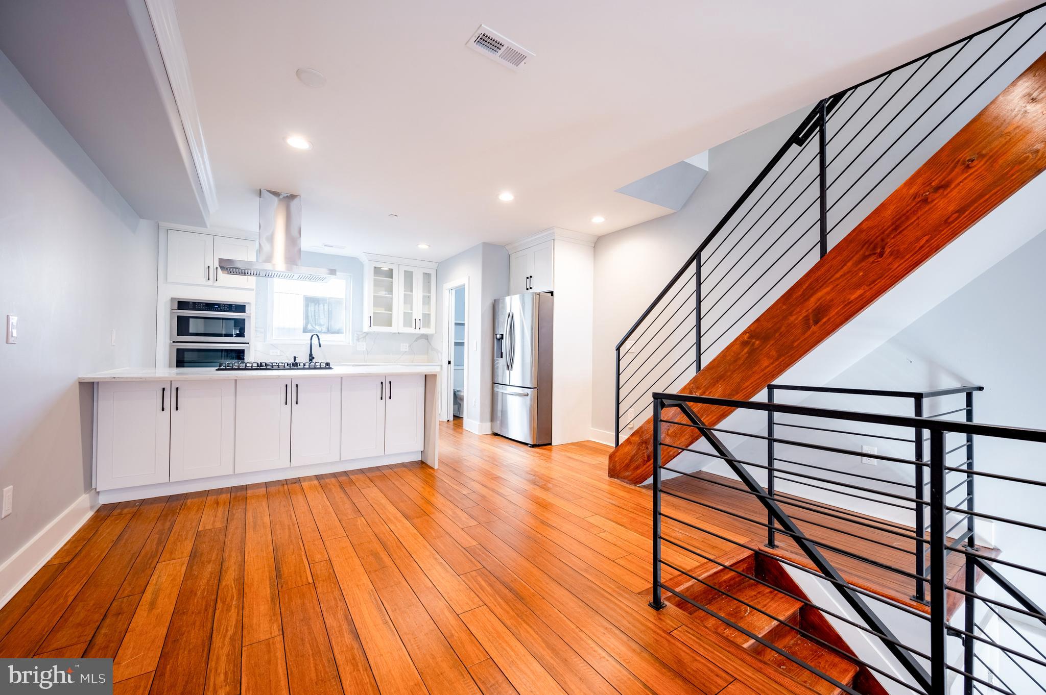605 McClellan Street Philadelphia, PA 19148 - Photo 11 of 26 a view of kitchen with cabinets and wooden floor