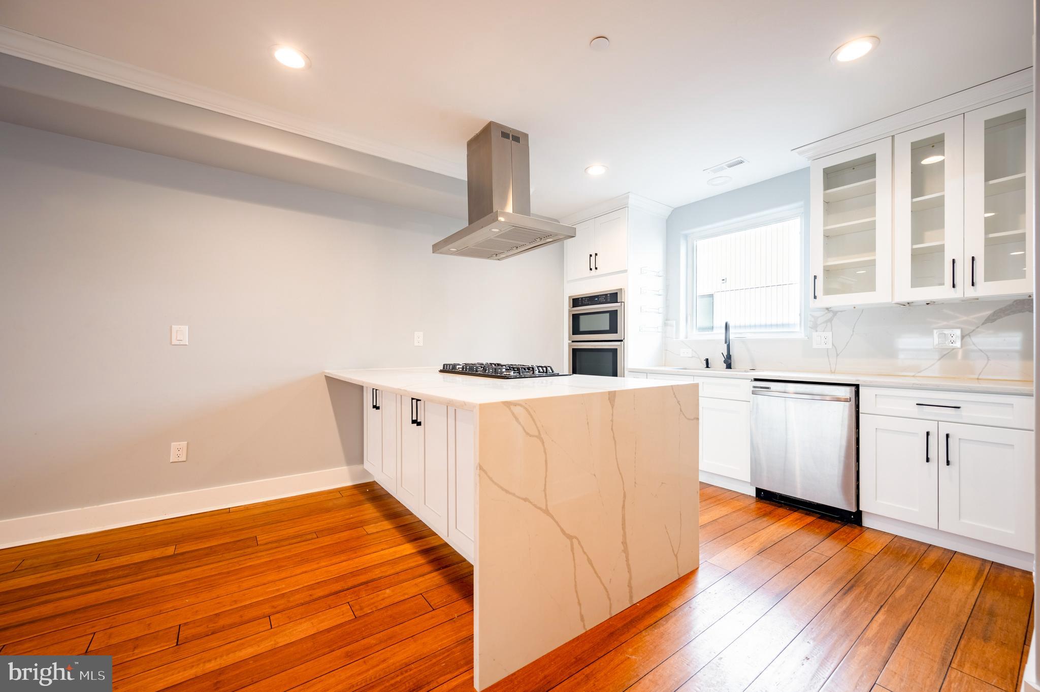 605 McClellan Street Philadelphia, PA 19148 - Photo 14 of 26 a kitchen with stainless steel appliances a white stove top oven and a chandelier
