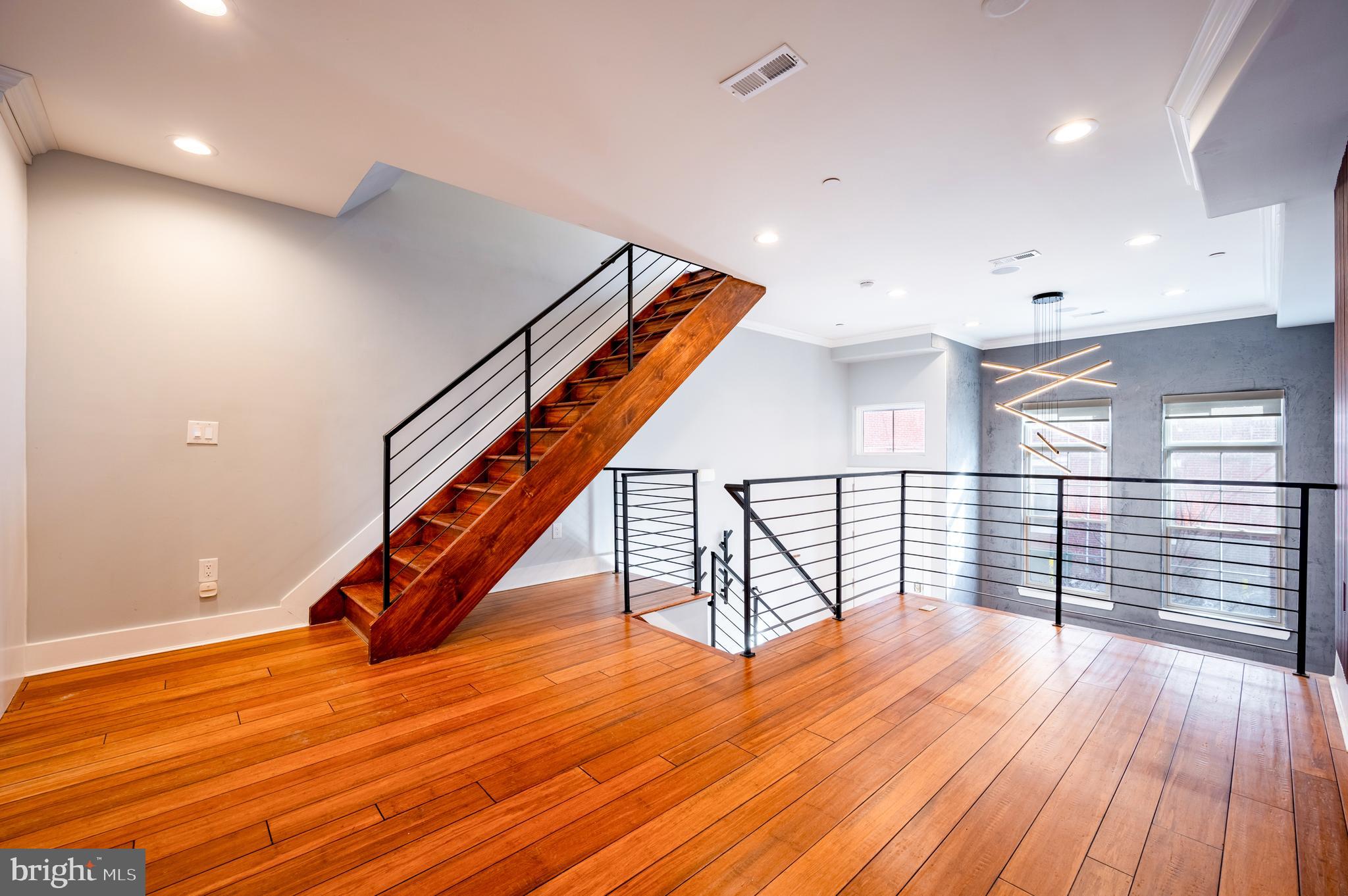 605 McClellan Street Philadelphia, PA 19148 - Photo 20 of 26 an empty room with wooden floor and stairs