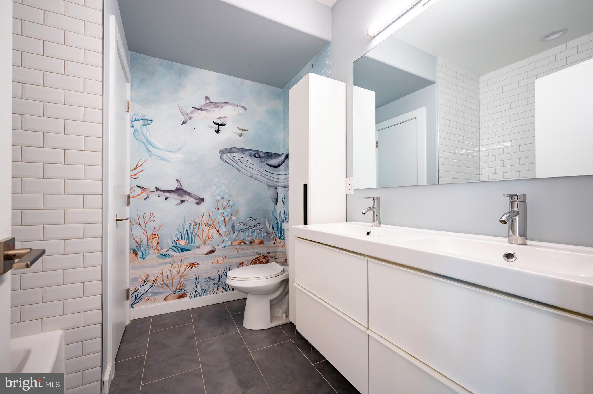 605 McClellan Street Philadelphia, PA 19148 - Photo 23 of 26 a bathroom with a toilet sink and mirror