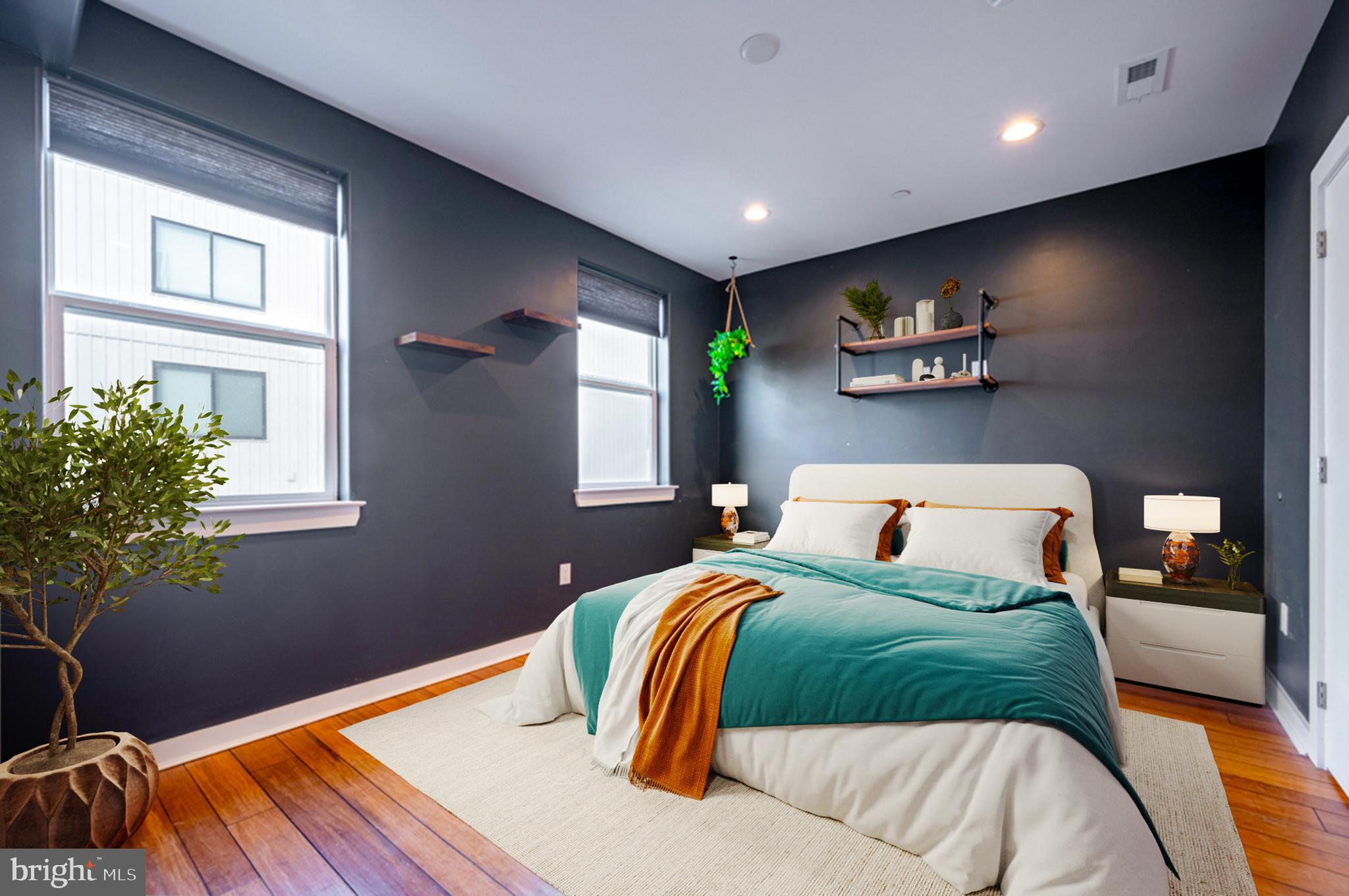 605 McClellan Street Philadelphia, PA 19148 - Photo 7 of 26 a bedroom with a bed and a potted plant