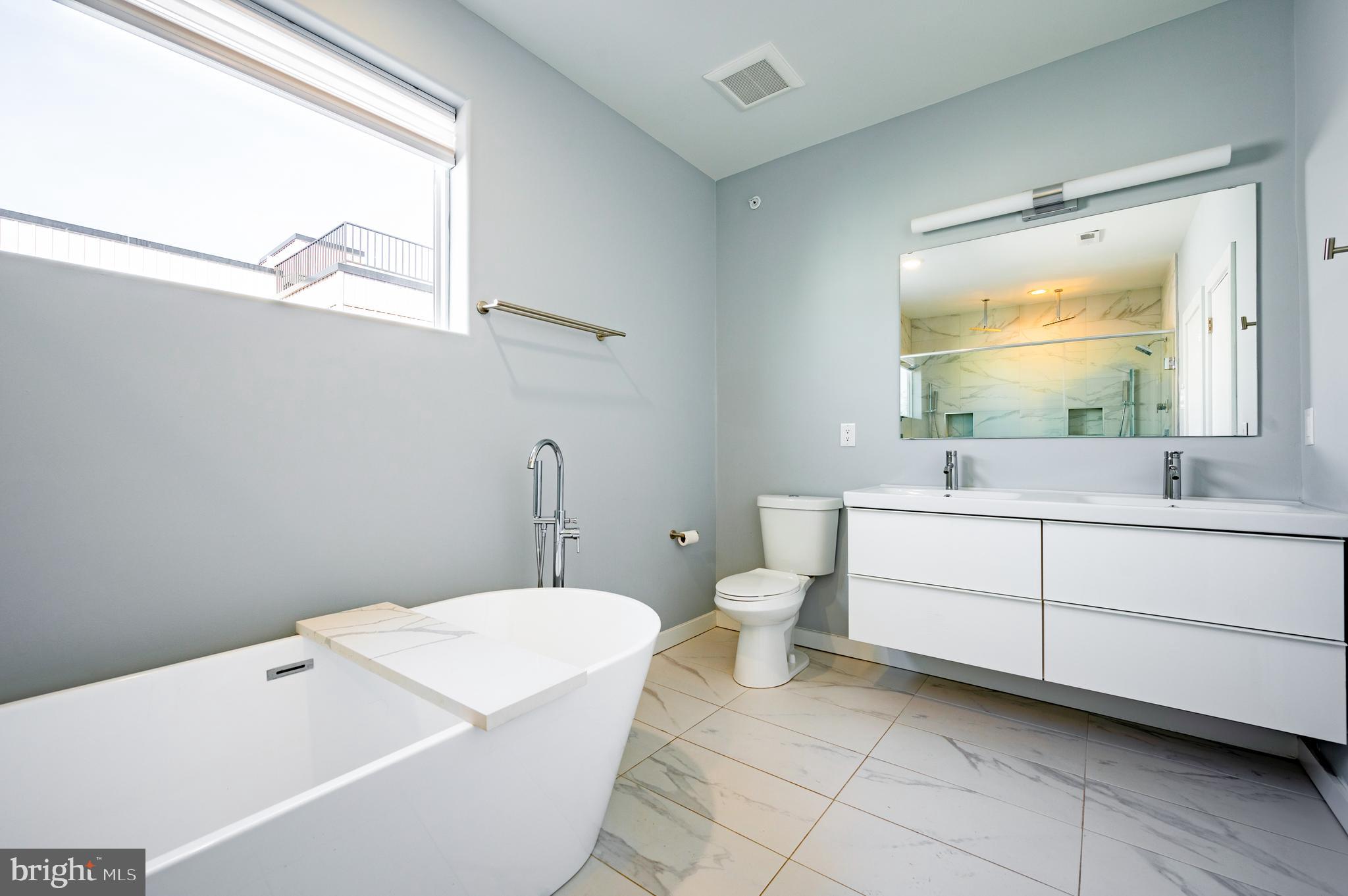 605 McClellan Street Philadelphia, PA 19148 - Photo 10 of 26 a bathroom with a sink a toilet and mirror