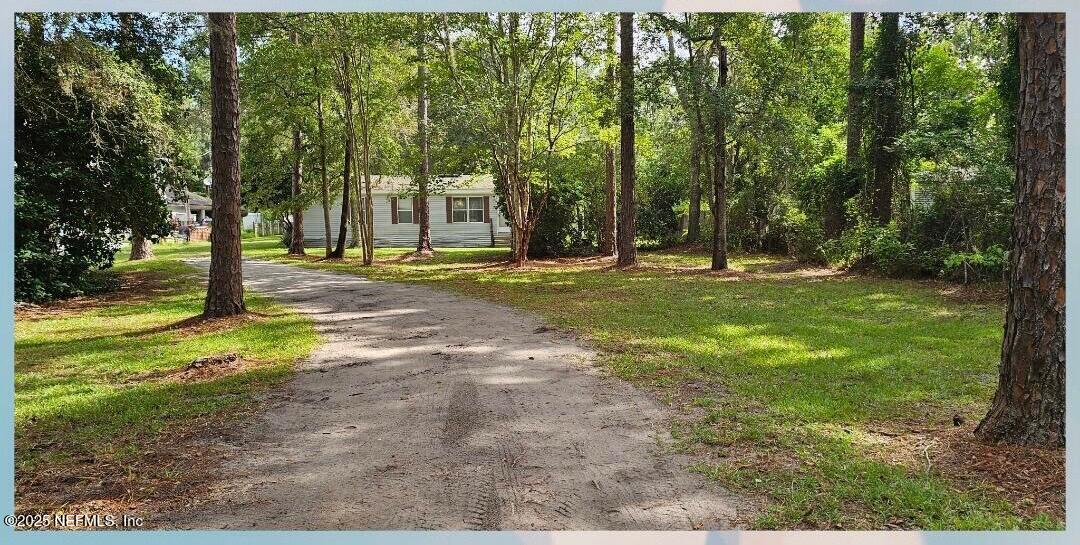 1285 Scott Road St. Johns, FL 32259 - Photo 1 of 20 a backyard of a house with a yard and outdoor seating