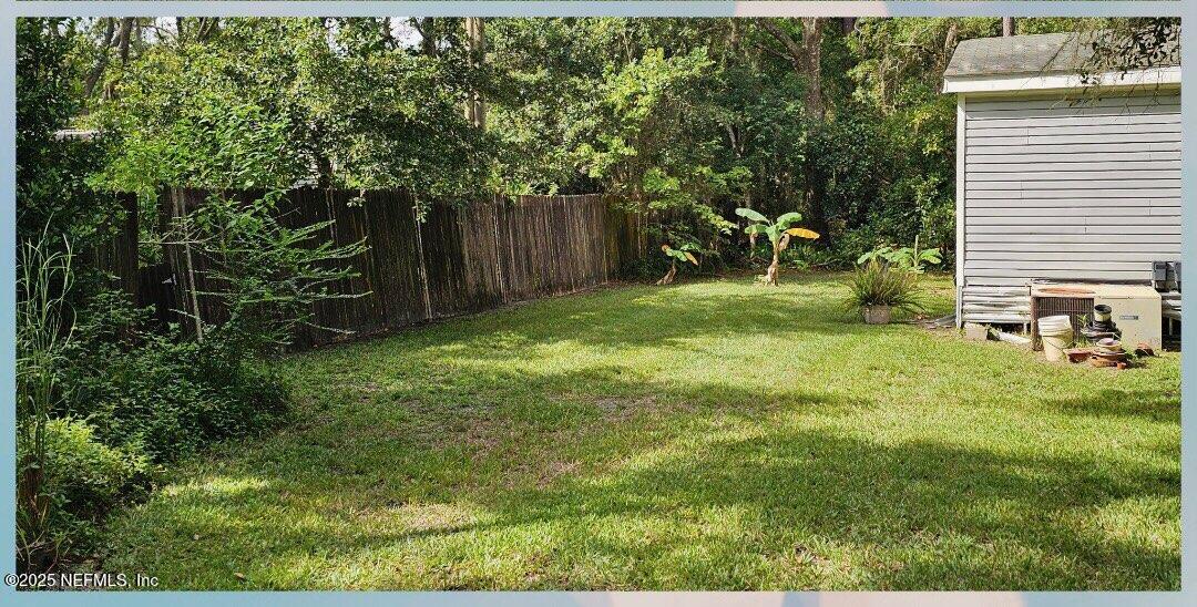 1285 Scott Road St. Johns, FL 32259 - Photo 4 of 20 a view of a backyard with table and chairs and wooden fence