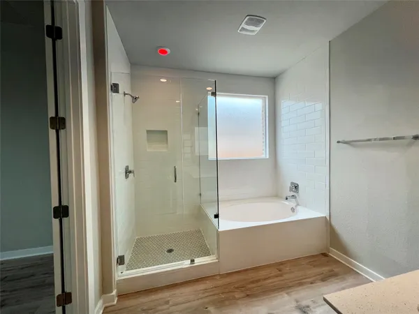 a bathroom with a bathtub and a shower