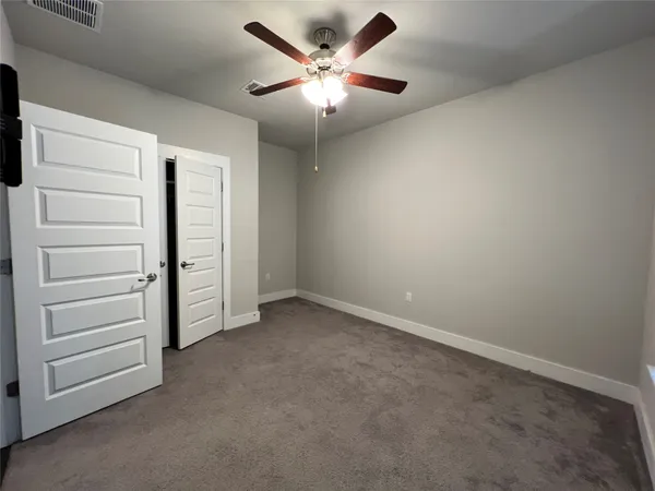 an empty room with a ceiling fan