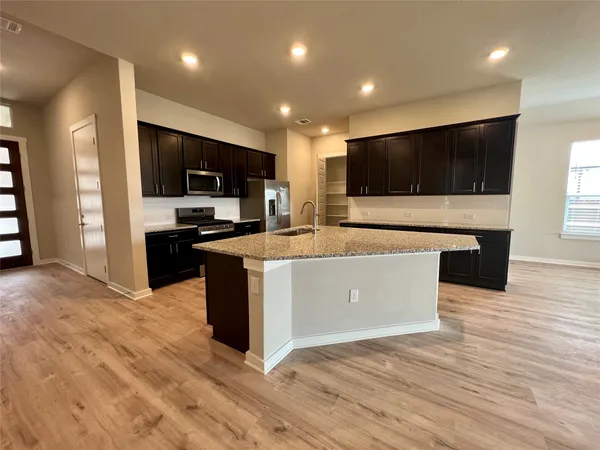 a view of kitchen with microwave oven and cabinets